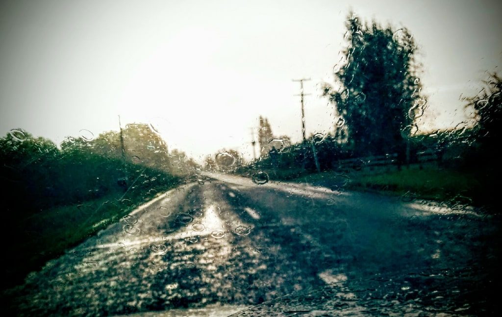 Driving through the rain on a country road on the other side of the world