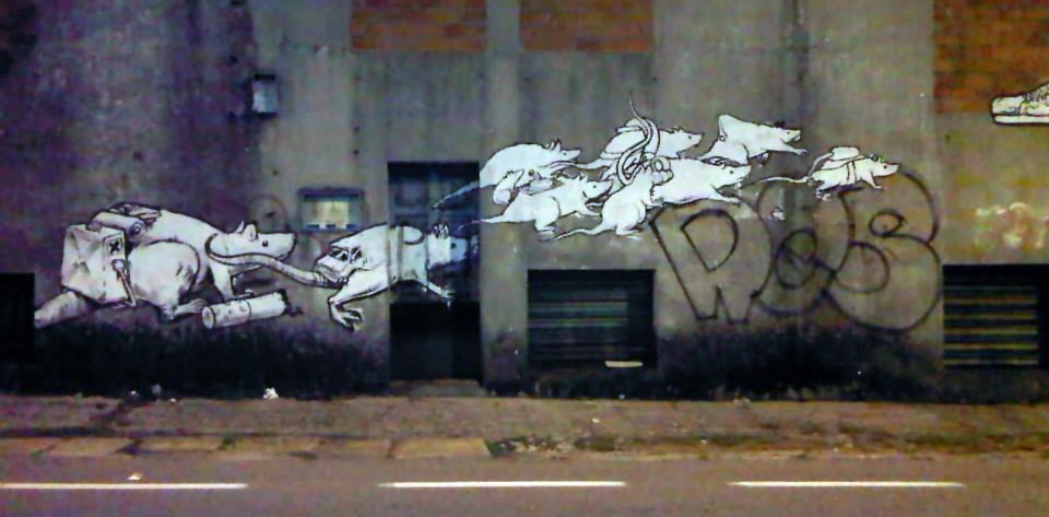 Street graffiti illustrating a rat race